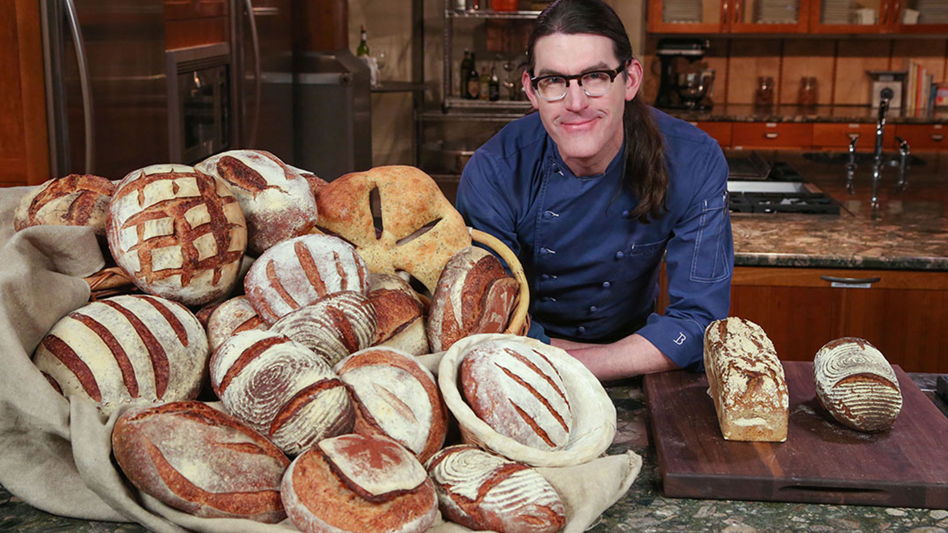 Man with a pile of sourdough bread